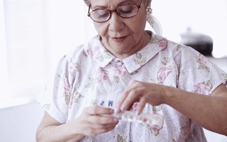 older woman taking medication