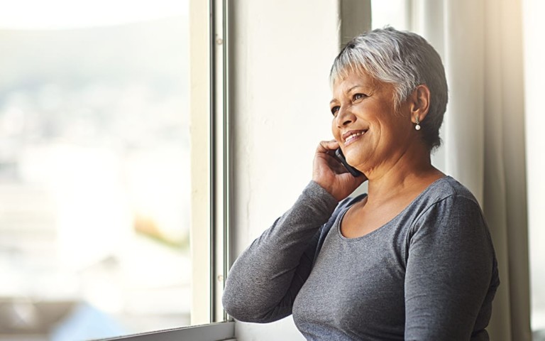 smiling older woman talking on phone