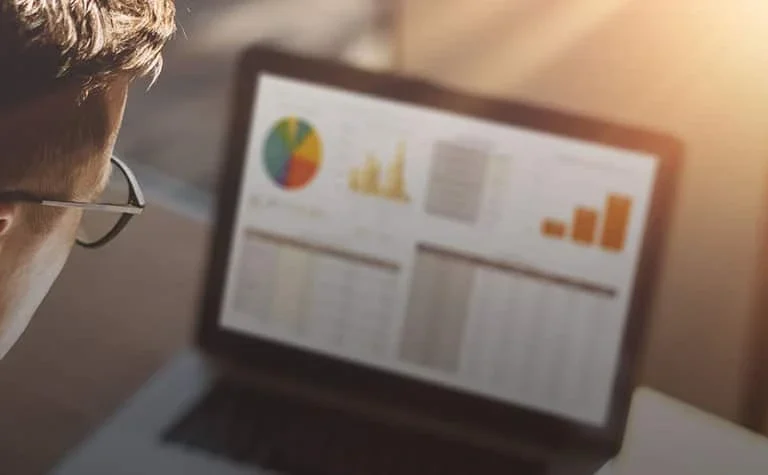 man wearing glasses looking at tablet