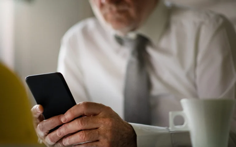 man in business dress holding phone