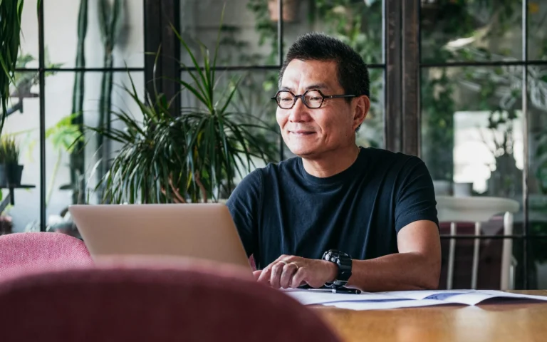 man wearing glasses working at computer