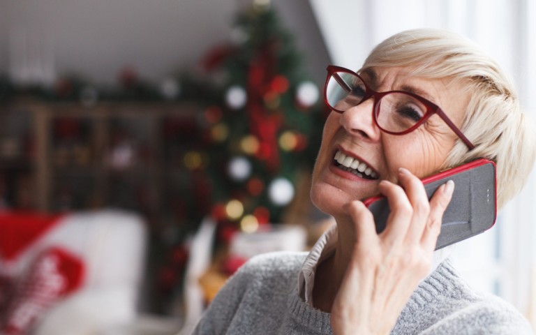 older woman laughing talking on phone