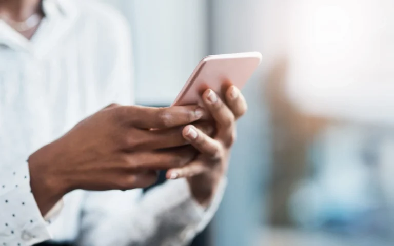 woman's hands scrolling on phone