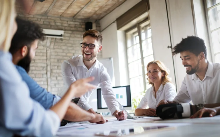 employees laughing at a conference table