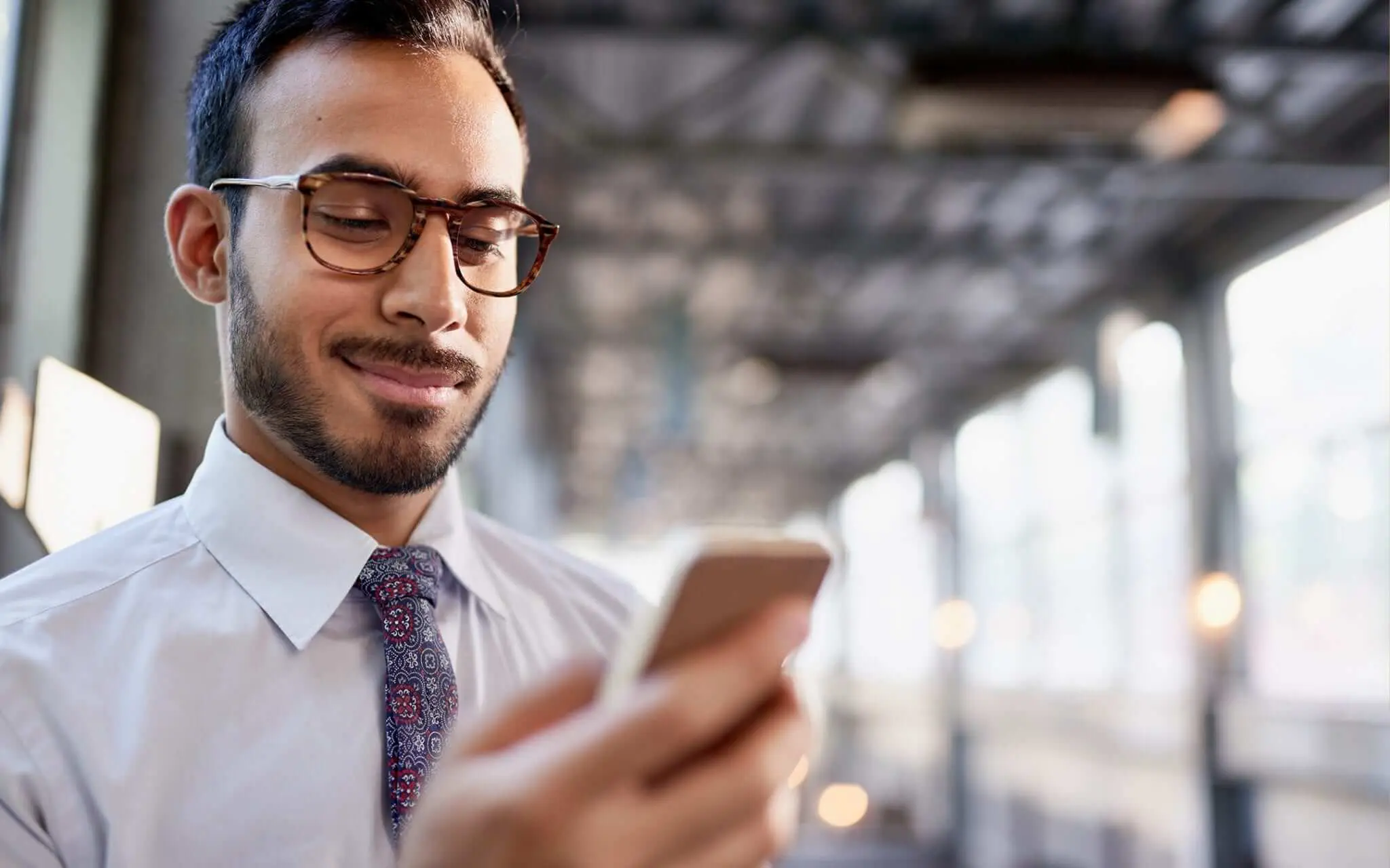 man in business dress looking at phone