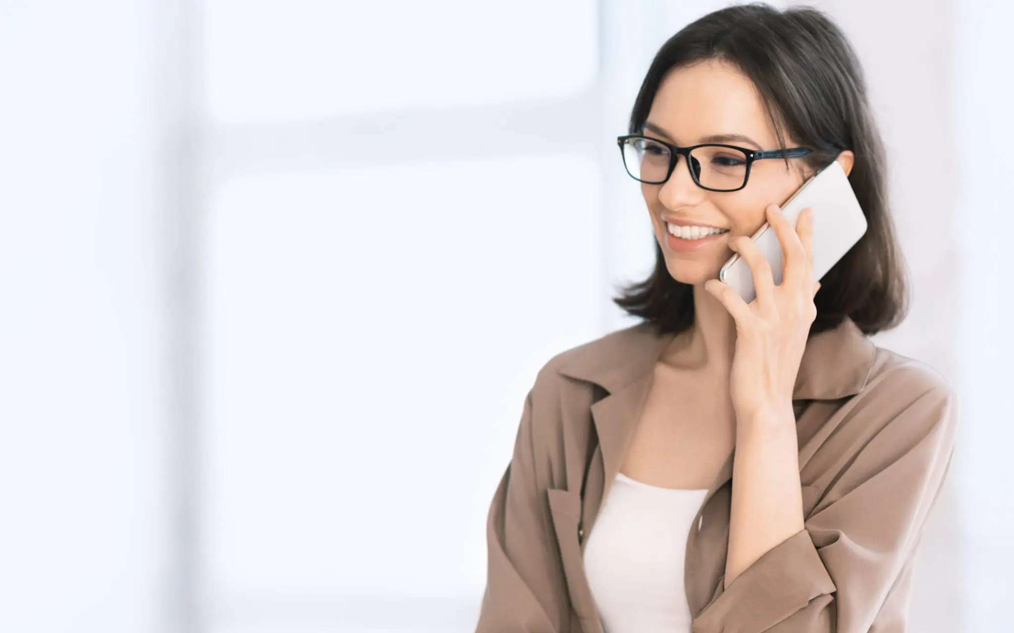 Smiling woman talking on smartphone