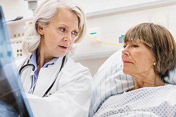 doctor showing patient xray in hospital