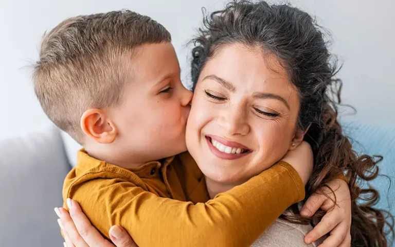 child kissing mother