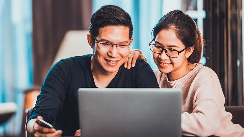 young couple using laptop