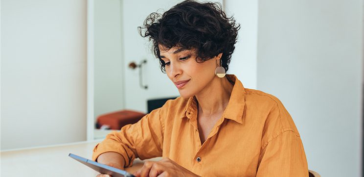 woman using tablet computer to schedule online