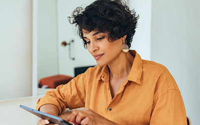 woman using tablet computer to schedule online