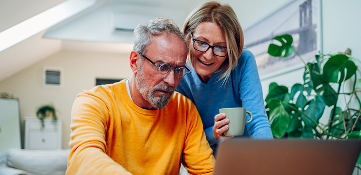 man and woman using computer to schedule appointment online