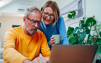 man and woman using computer to schedule appointment online