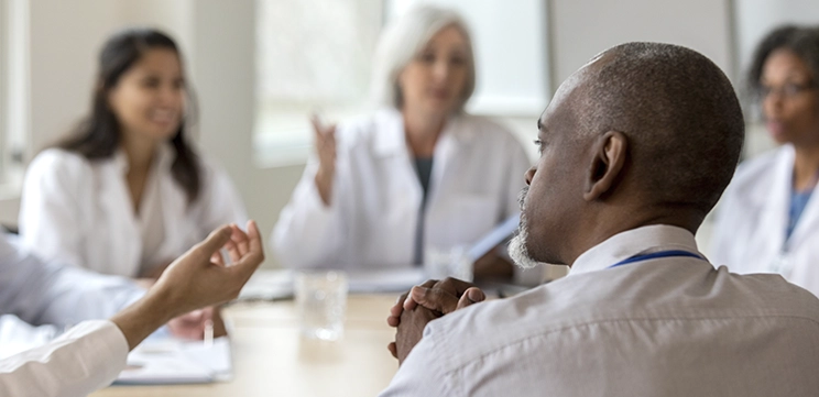 Healthcare professionals discussing payer operations and digital transformation at Carenet Health.