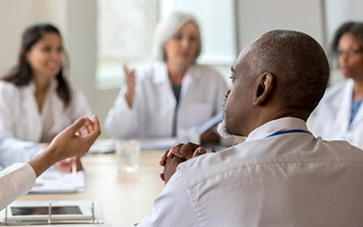 Healthcare professionals discussing payer operations and digital transformation at Carenet Health.