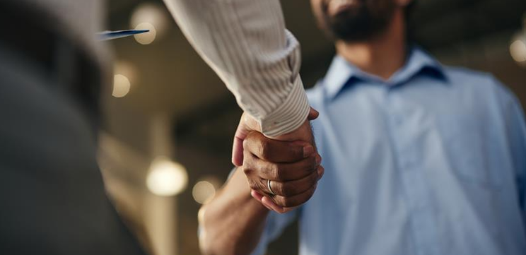 Healthcare professionals shaking hands, representing Carenet Health's Everest Group PEAK Matrix recognition